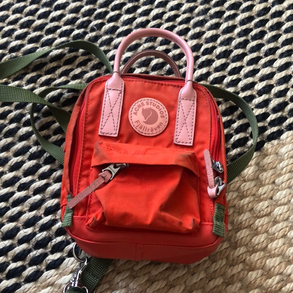 Fjallraven mini backpack in red with pink handles and green straps